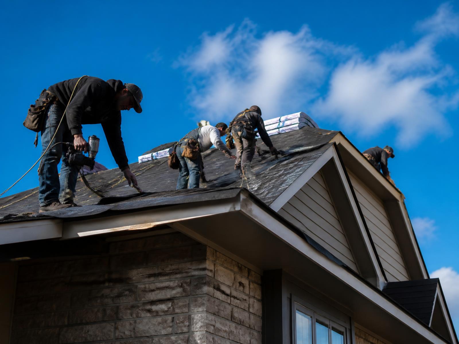 Roofing crew working on a residential home