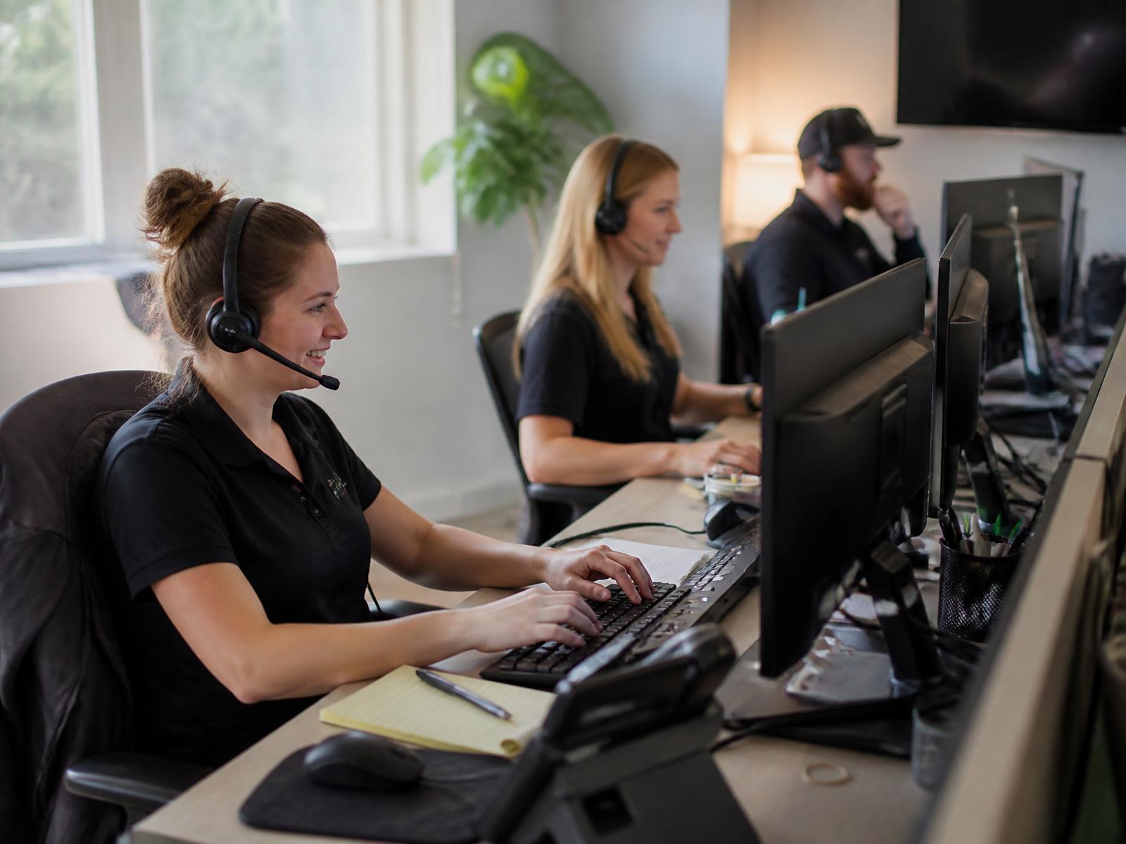Office team answering customer calls and scheduling estimates
